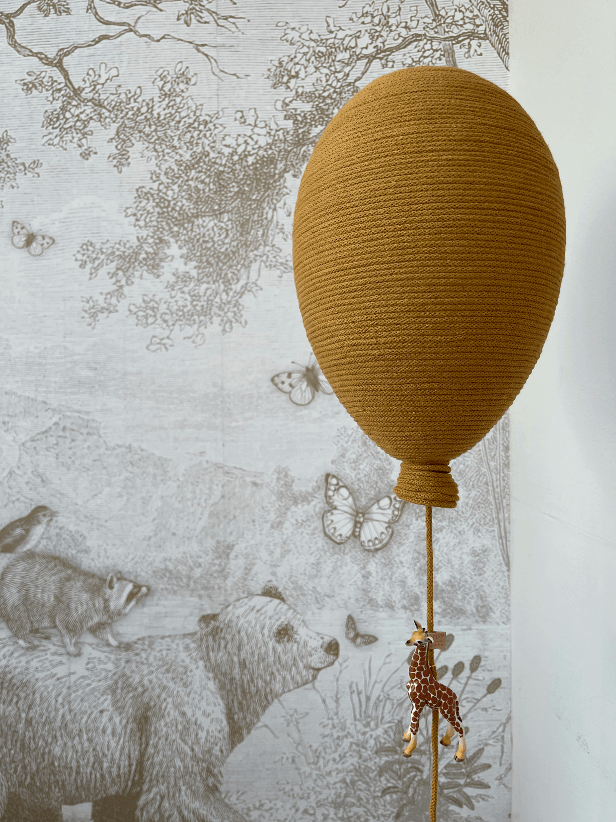 Ochre hot air balloon wall decor for baby nursery with giraffe detail, perfect for baby shower and gender reveal decorations.